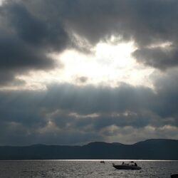 Sun shining through clouds on Lake George